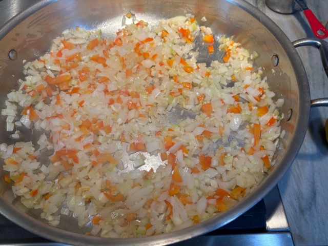 Soften the vegetables in the oil.