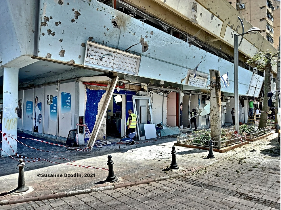 Holon: View of area where a Hamas rocket scored a direct hit on a bus, showing damage to adjacent shops