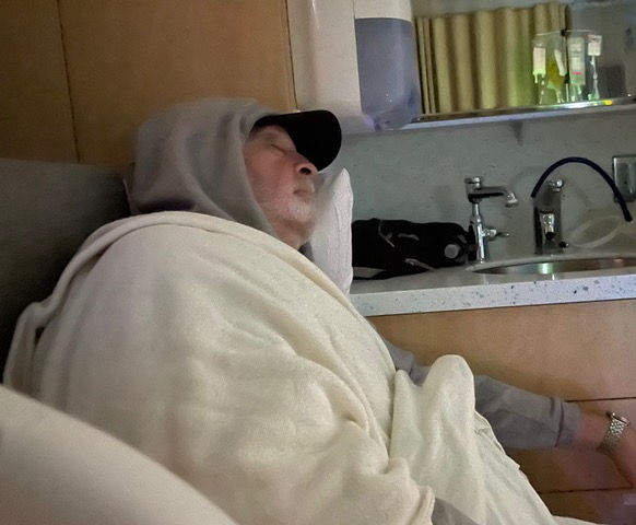 My devoted husband, Bob, sleeping in my hospital room