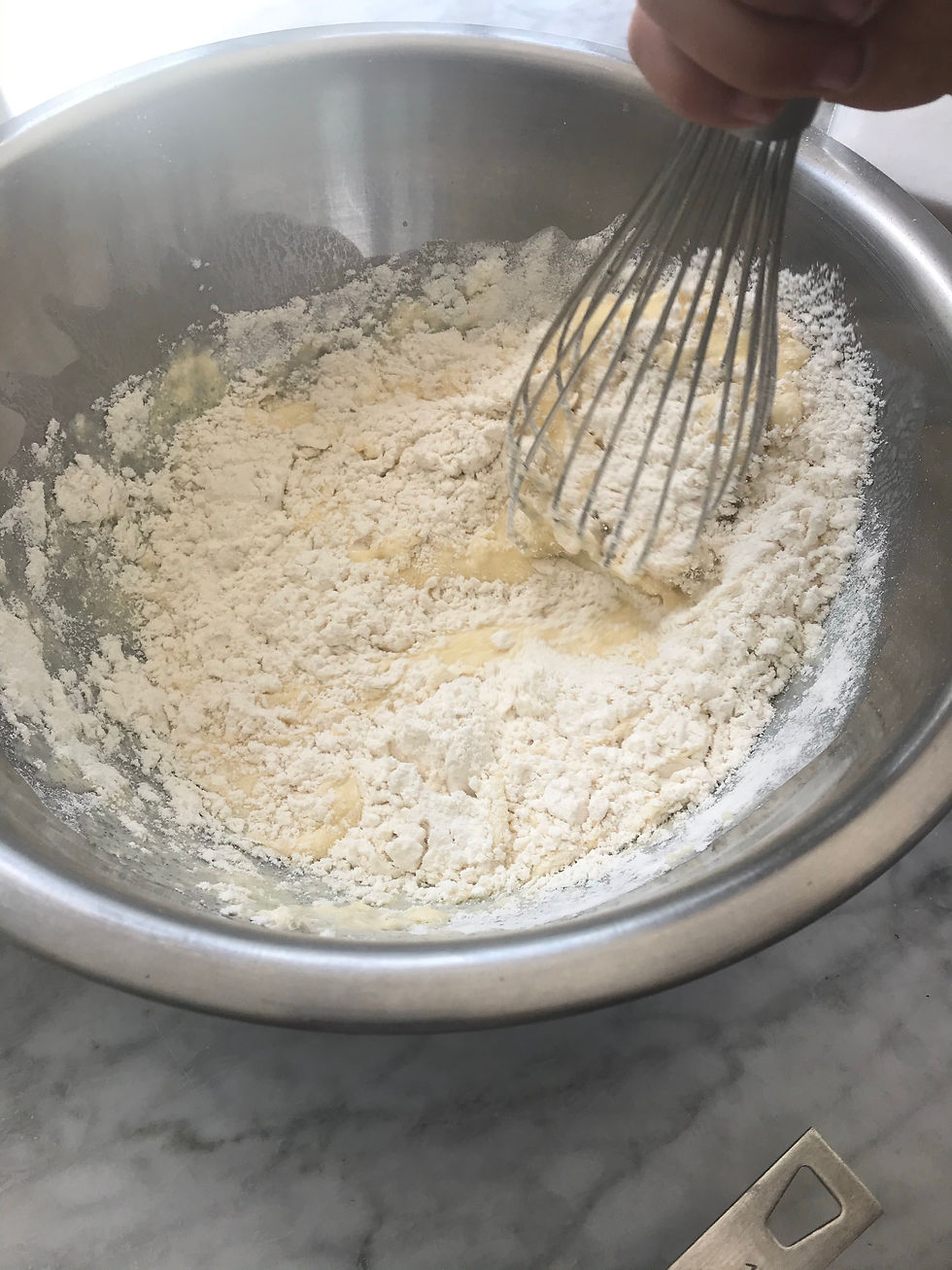Blending in flour. If batter too thick, thin with more buttermilk