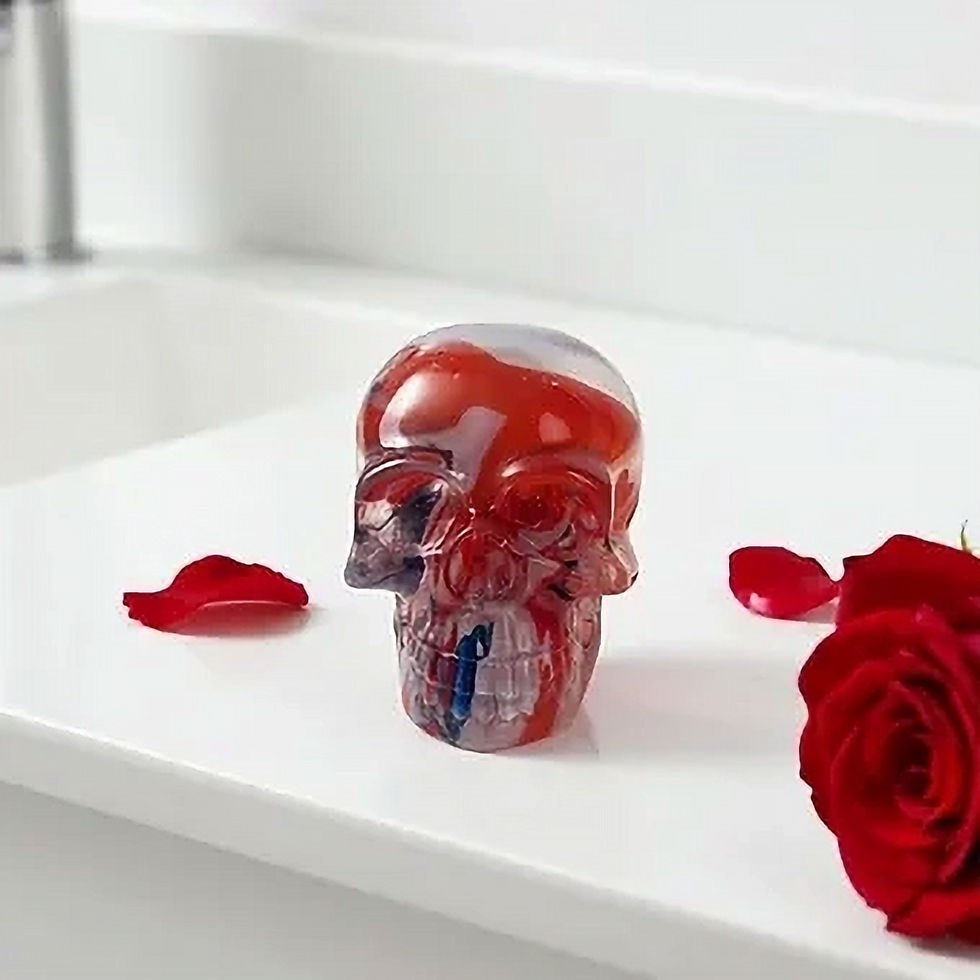 Handmade resin skull with red liquid, rose petals, and red rose.