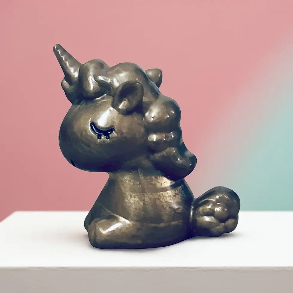 Gold Baby Unicorn Statue Left Side View On A Shelf, With Pink Wall