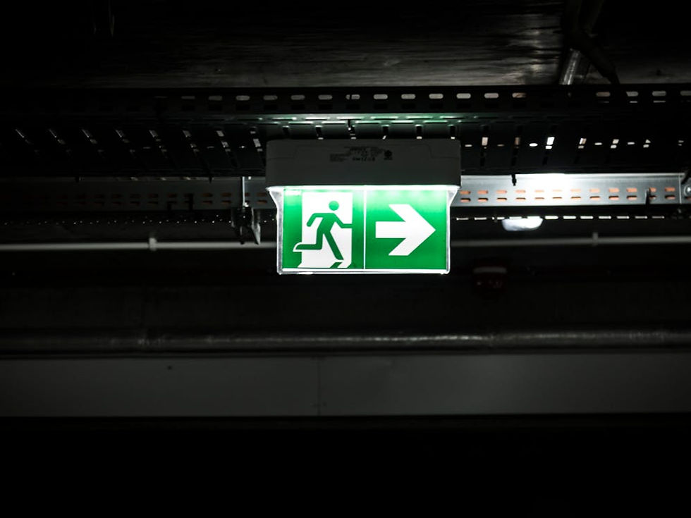 Green and white emergency exit sign