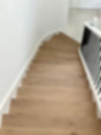 Curved staircase hardwood flooring remodel in Lake Worth Florida home