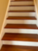 Stair tread refinishing with rich wood stain in Delray Beach Florida home