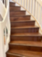 Curved hardwood staircase refinishing in Palm City Florida residence