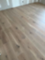 Matte finish wide plank white oak hardwood floors professionally installed by a contractor.