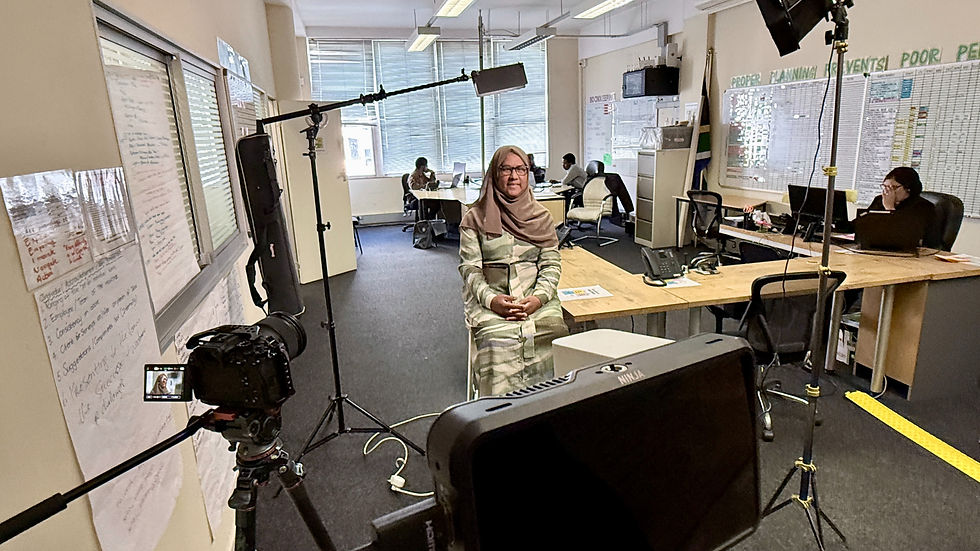 Office setting with interviewee seated for filming