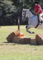 Jumping hay bales out in open field