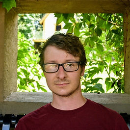 Author Andrew Maust in front of an outdoor window