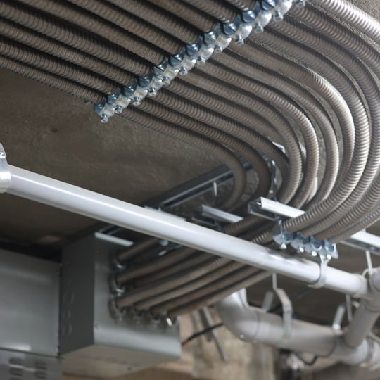 aClean conduit runs and feeders in a multi-unit building electrical room, M&L Electric Ottawa