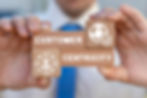 Person holding blocks that say customer centricity with a smiley face