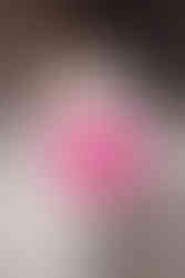 women in white suit at photoshootwith sunglasses and curled hairstyle