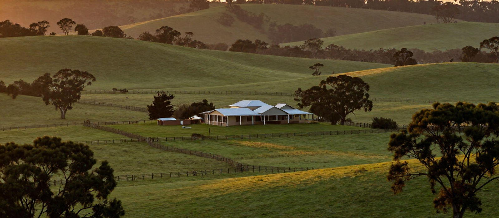 A farmhouse on rolling green farmland