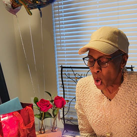 Sheryl blowing out birthday candles.