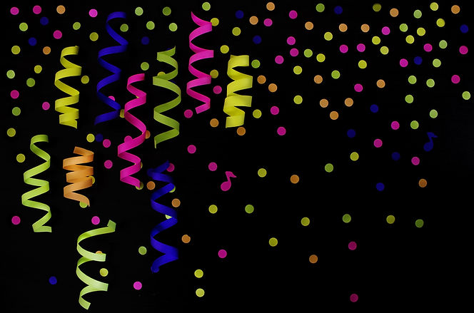 Festive vibrant confetti and ribbons on