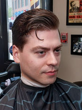 Classic side part men’s haircut with tapered sides and styled volume on top