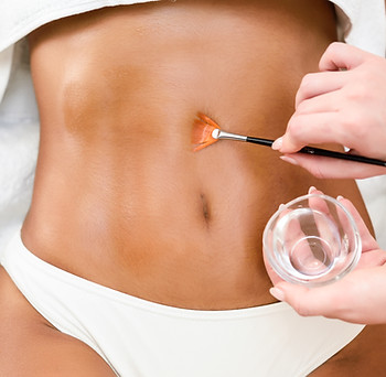 woman-receiving-belly-massage-treatment-with-oil-brush.jpg