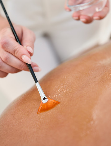 woman-receiving-back-massage-treatment-with-oil-brush.jpg