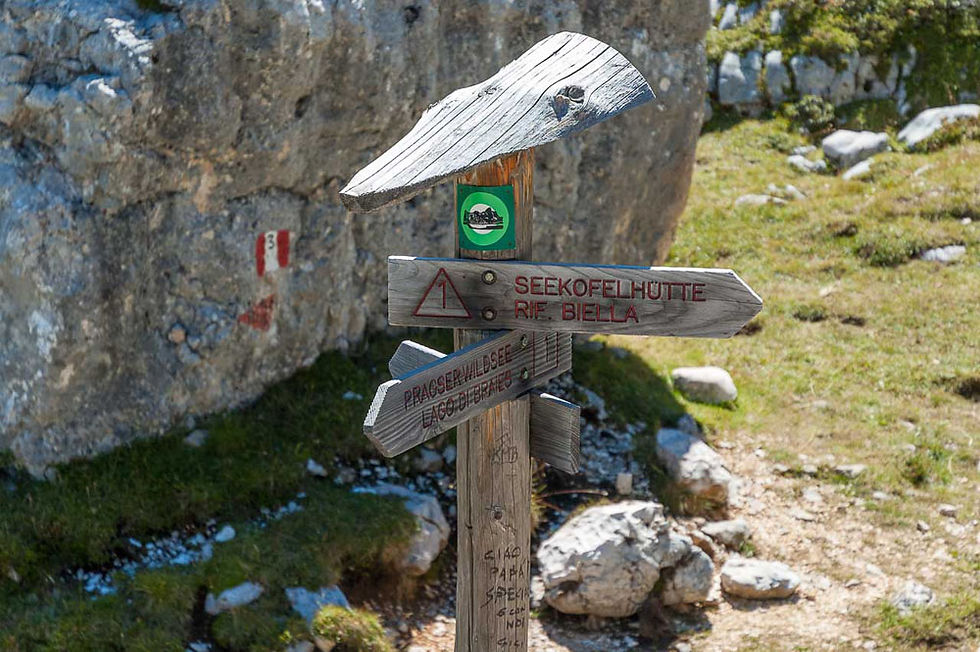 Self Guided Hiking Dolomites tour – hikers on a trail with panoramic Dolomite peaks, part of Hiking Dolomites Self Guided itineraries.