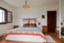 Large bed with wooden door to right