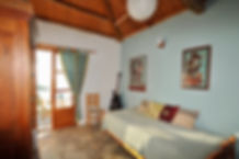 Bedroom with stone floor and french windows