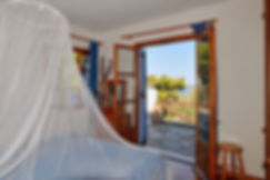 Bed with mosquito net with window to side