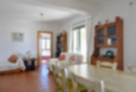 Dining table and french windows behind.