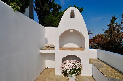 Greek brick built BBQ with seating area.