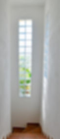 Stairwell of villa with glass bricks in walls.