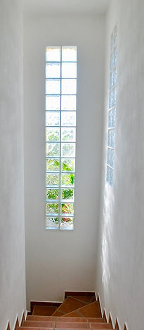 Stairwell of villa with glass bricks in walls.