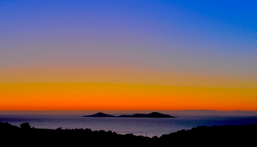 A beautiful sunrise showing orange sky and the islands around Alonissos, Greece.