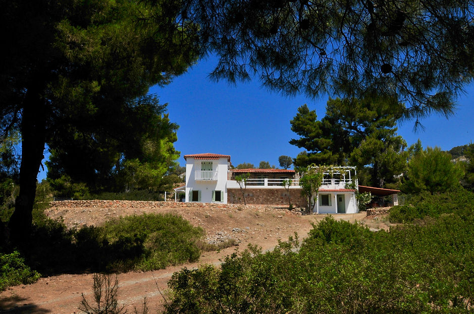 View of Greek villa through tress with b