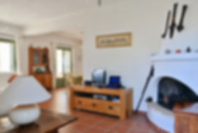 Living room with large corner fireplace.