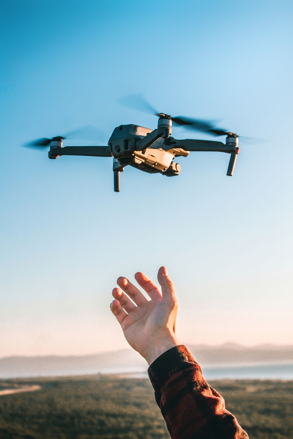 vertical-shot-of-a-person-launching-a-modern-drone-2023-11-27-05-30-32-utc.jpeg