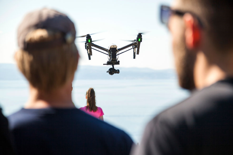 rear-view-of-man-and-woman-looking-at-drone-flying-2024-06-20-18-21-16-utc.jpg