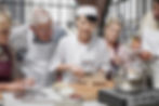 participants-in-cooking-class-watching-female-chef-2024-09-18-01-31-18-utc.jpg