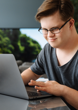 Young man with Down Syndrome on laptop