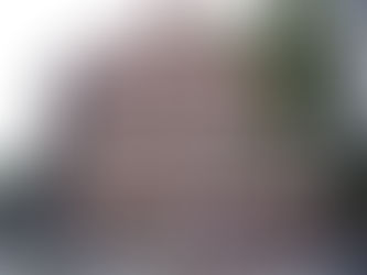 Visitors explore the historic Faneuil Hall in Boston, with a statue of Samuel Adams prominently standing nearby