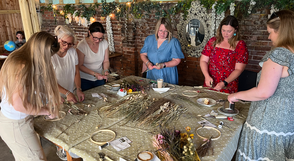 A group of women creating dried flower arrangements