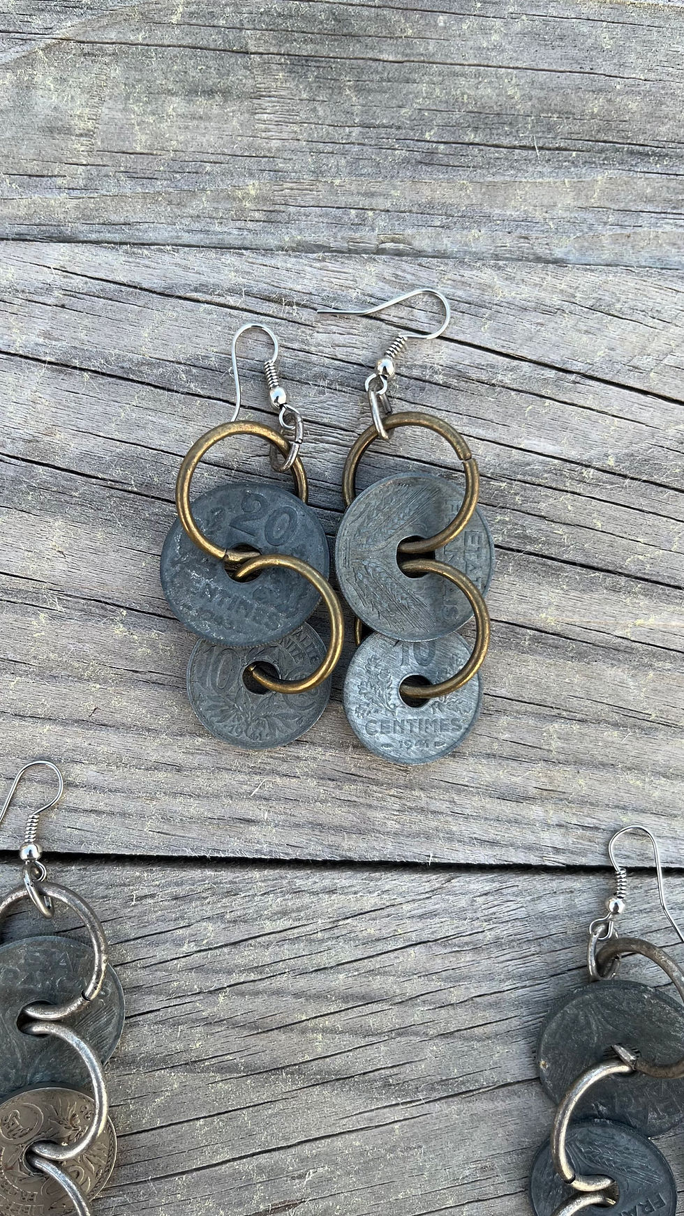 Thumbnail: Pair of earrings with coins, rings, and text 