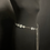Thumbnail: Silver chain belt on mannequin with coins, coins chain , dark background.