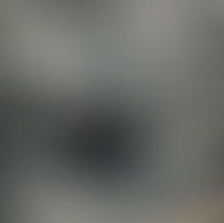 A distorted image of a person climbing on a sunlit outdoor rock wall, geometric features from the rock creating a dynamic effect. They are focused and determined, wearing climbing gear on their harness.