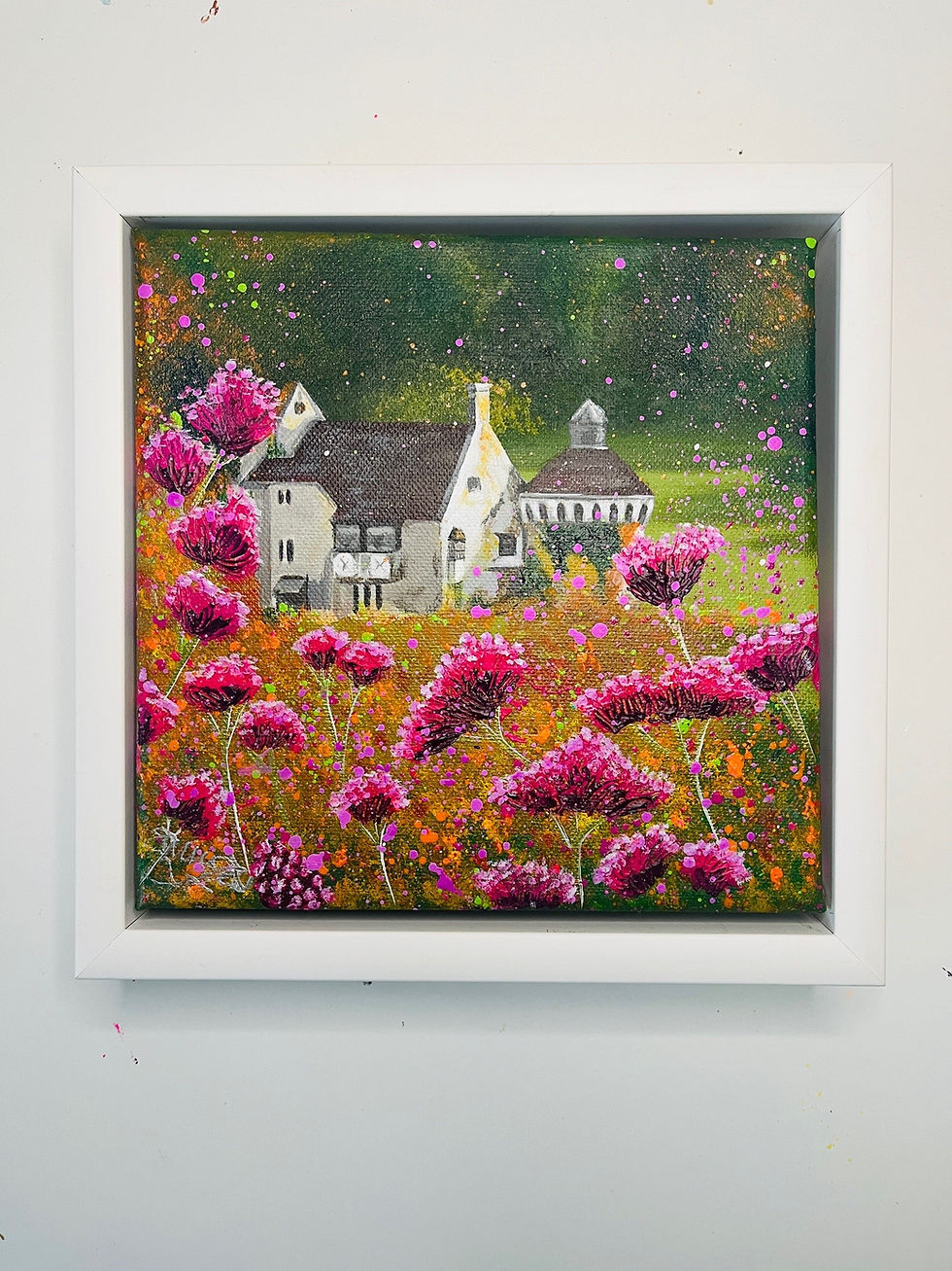 Pretty floral castle painting of grey Scotney castle and pink flowers in white frame.