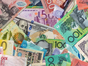 World currency on a pile