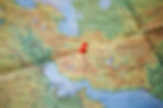 A map of the middle east with a red pin in Iran
