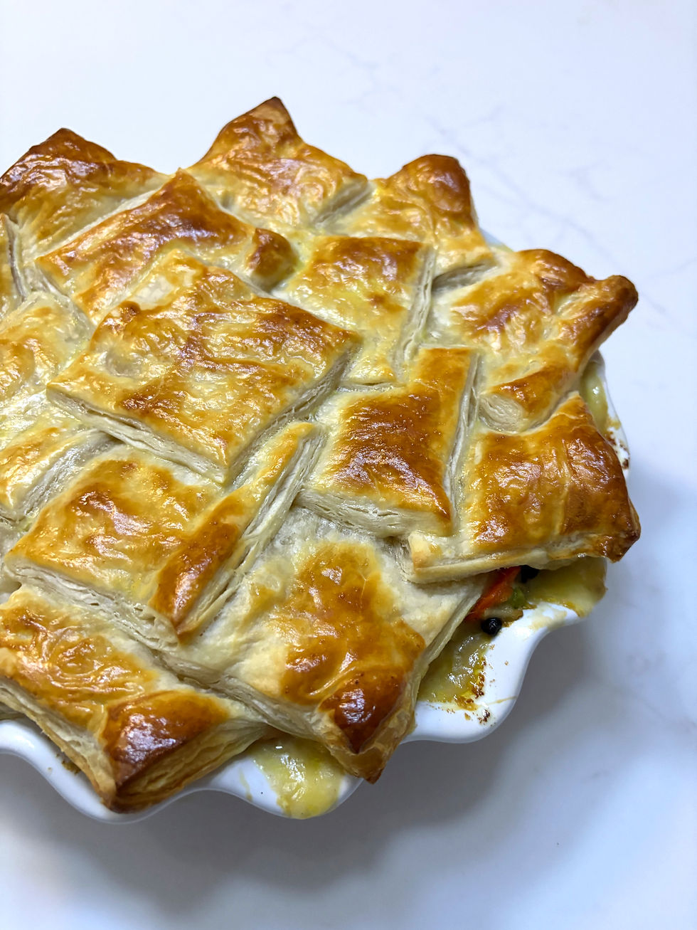 A chicken pot pie with a puff pastry crust