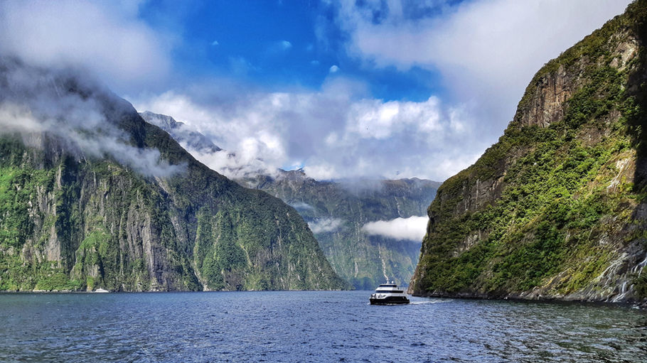Cruising beneath the cliffs of Milford Sound, New Zealand