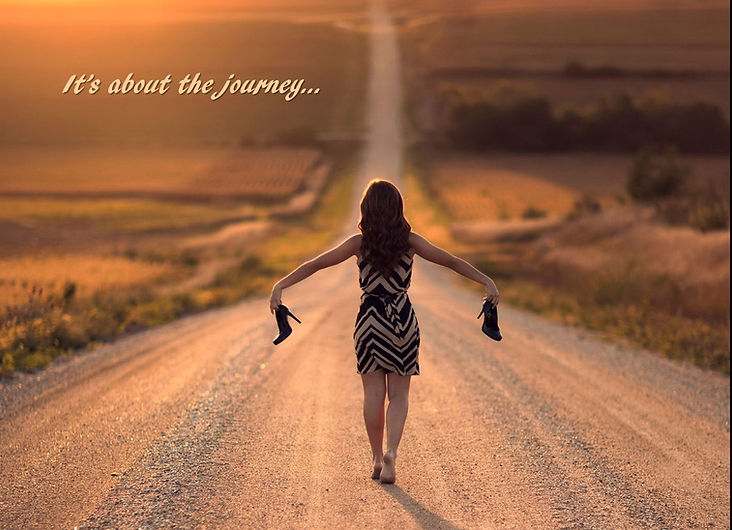 Woman walking a dirt road w/heels in hand
