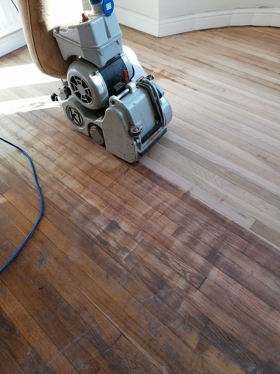 Oak floor with chatter marks and uneven sanding caused by incorrect use of a hire floor sanding machine